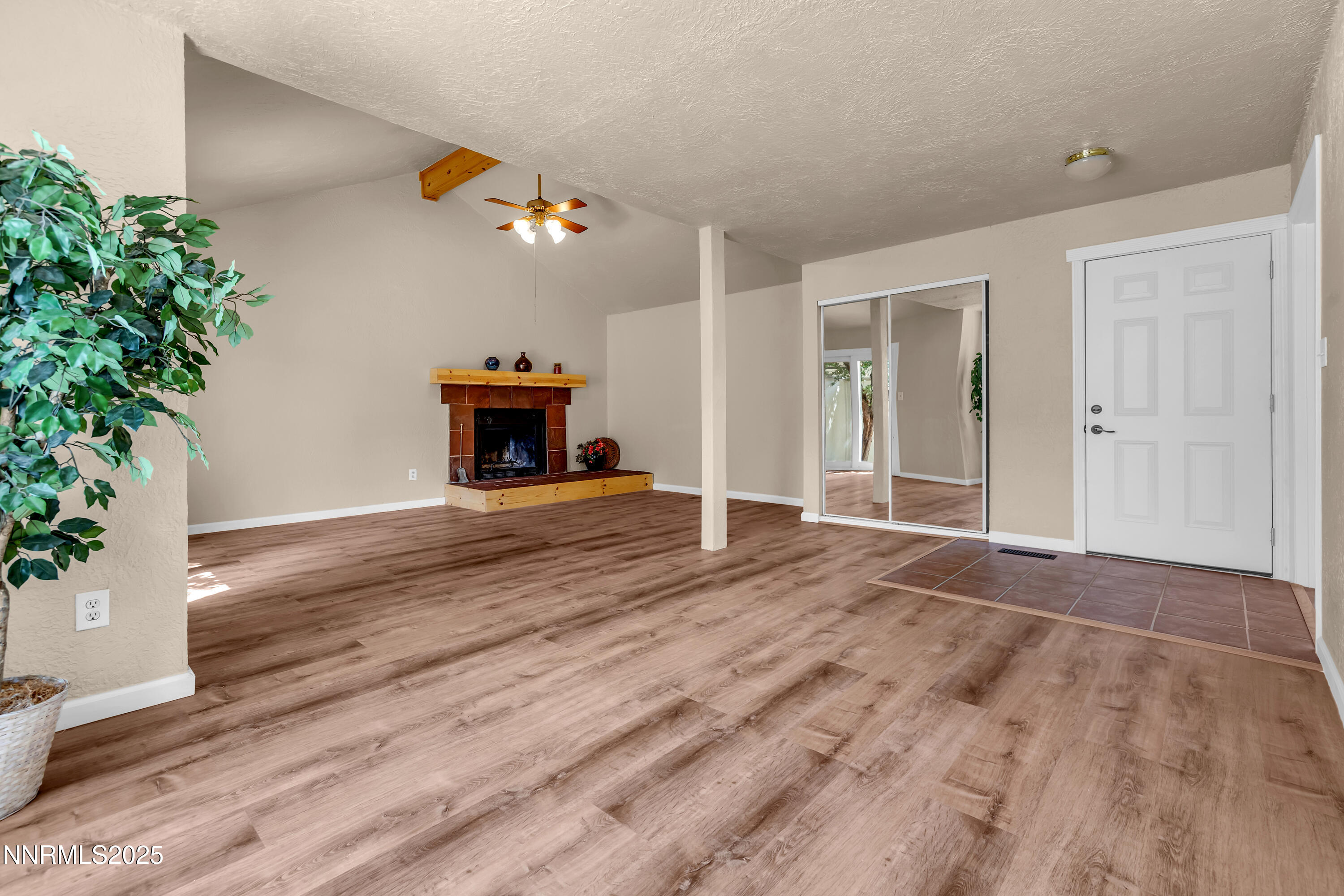 1265 Searchlite Court Reno, NV 89503 - Photo 3 of 43 an empty room with wooden floor and potted plants