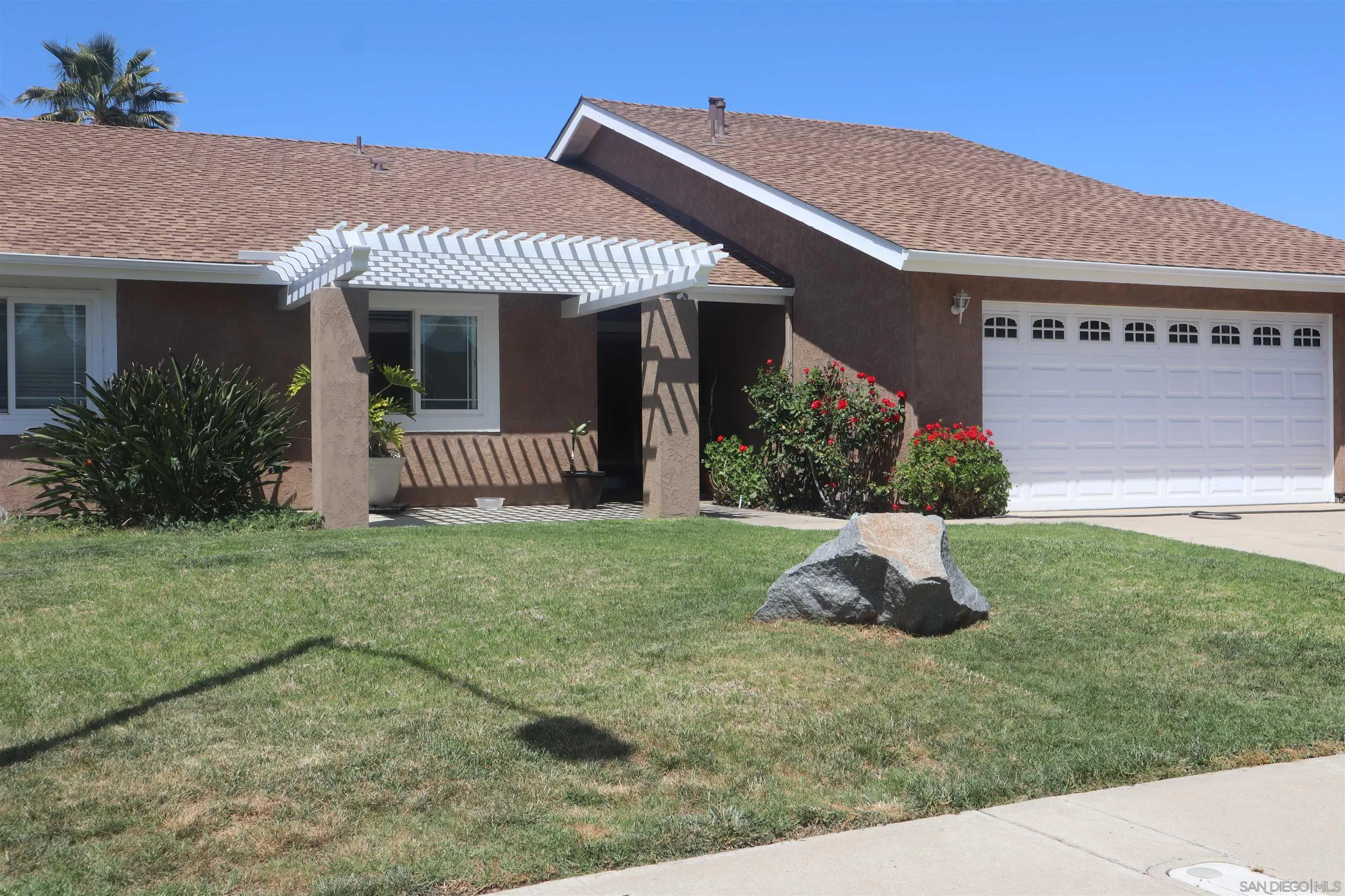 9212 Lake Hill Road Santee, CA 92071 - Photo 1 of 42 a front view of a house with a garden