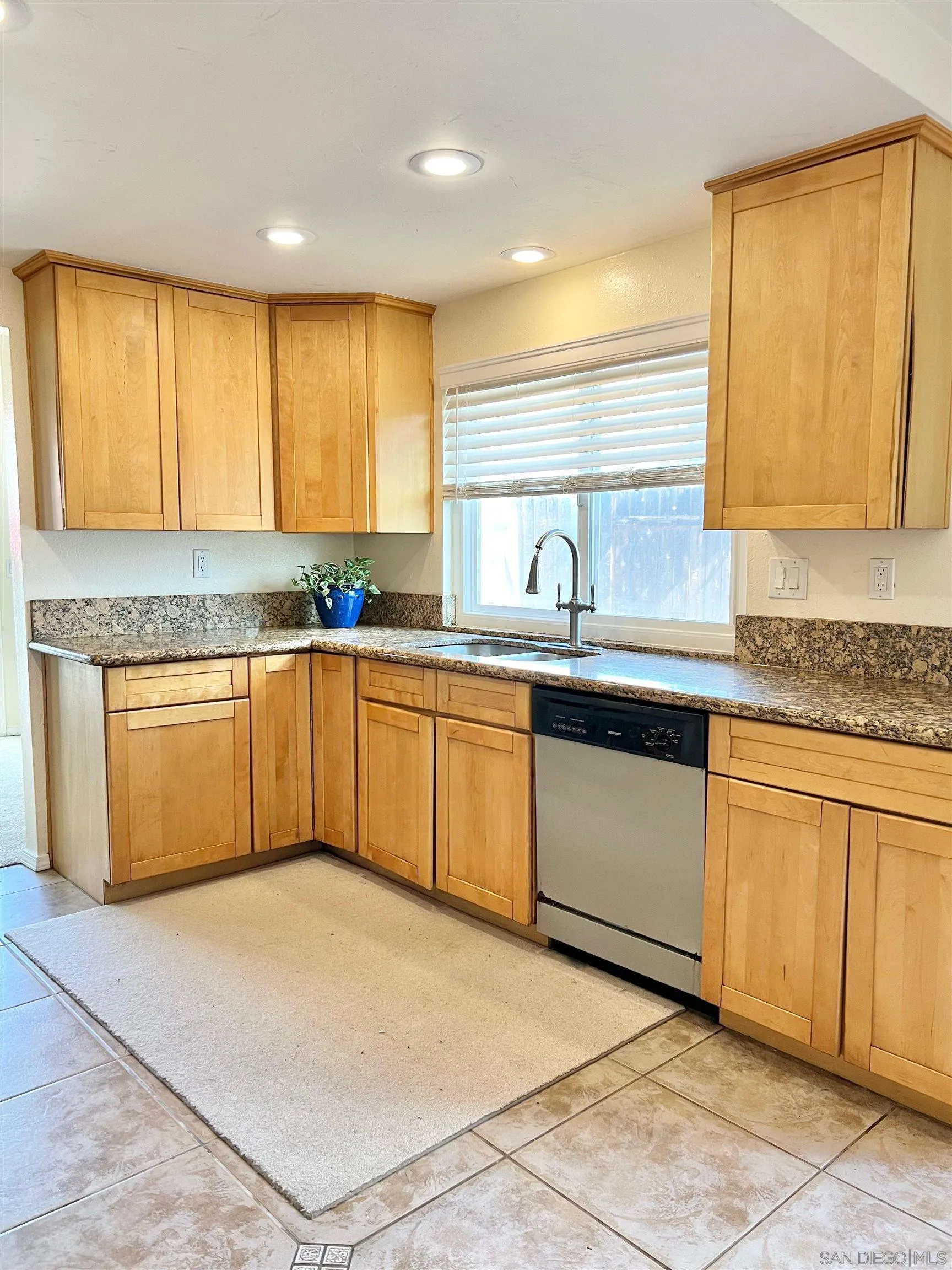 9212 Lake Hill Road Santee, CA 92071 - Photo 14 of 42 a kitchen with stainless steel appliances granite countertop a sink and cabinets