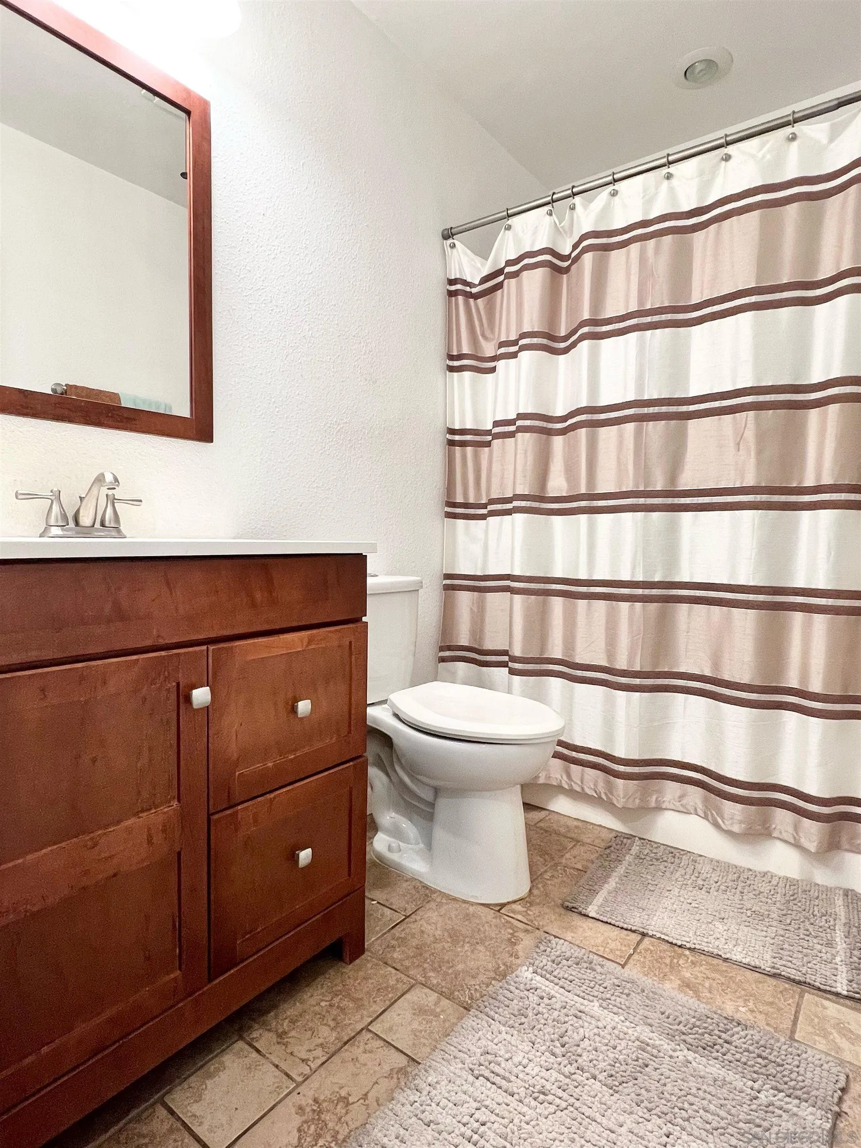 9212 Lake Hill Road Santee, CA 92071 - Photo 23 of 42 a bathroom with a toilet and a shower