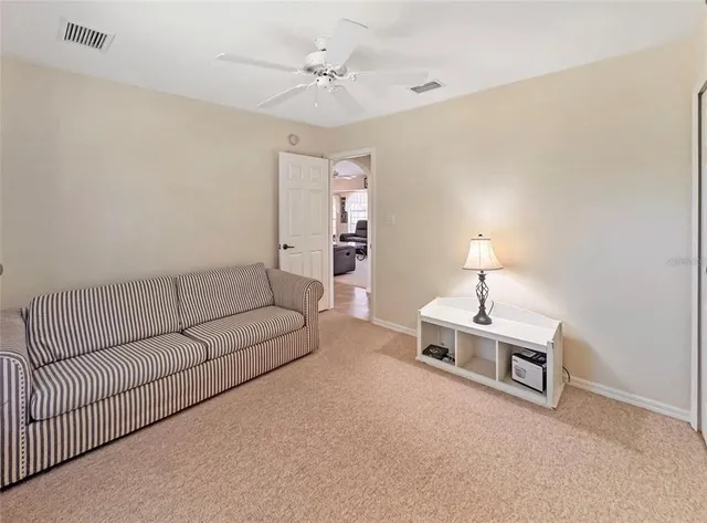 a living room with furniture a lamp and a chandelier