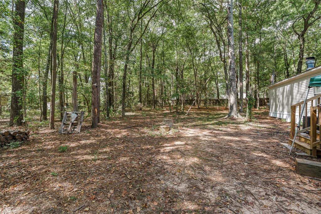 8273 Godfrey Road Shreveport, LA 71129 - Photo 26 of 27 Wooded property featuring mature trees and a fenced perimeter