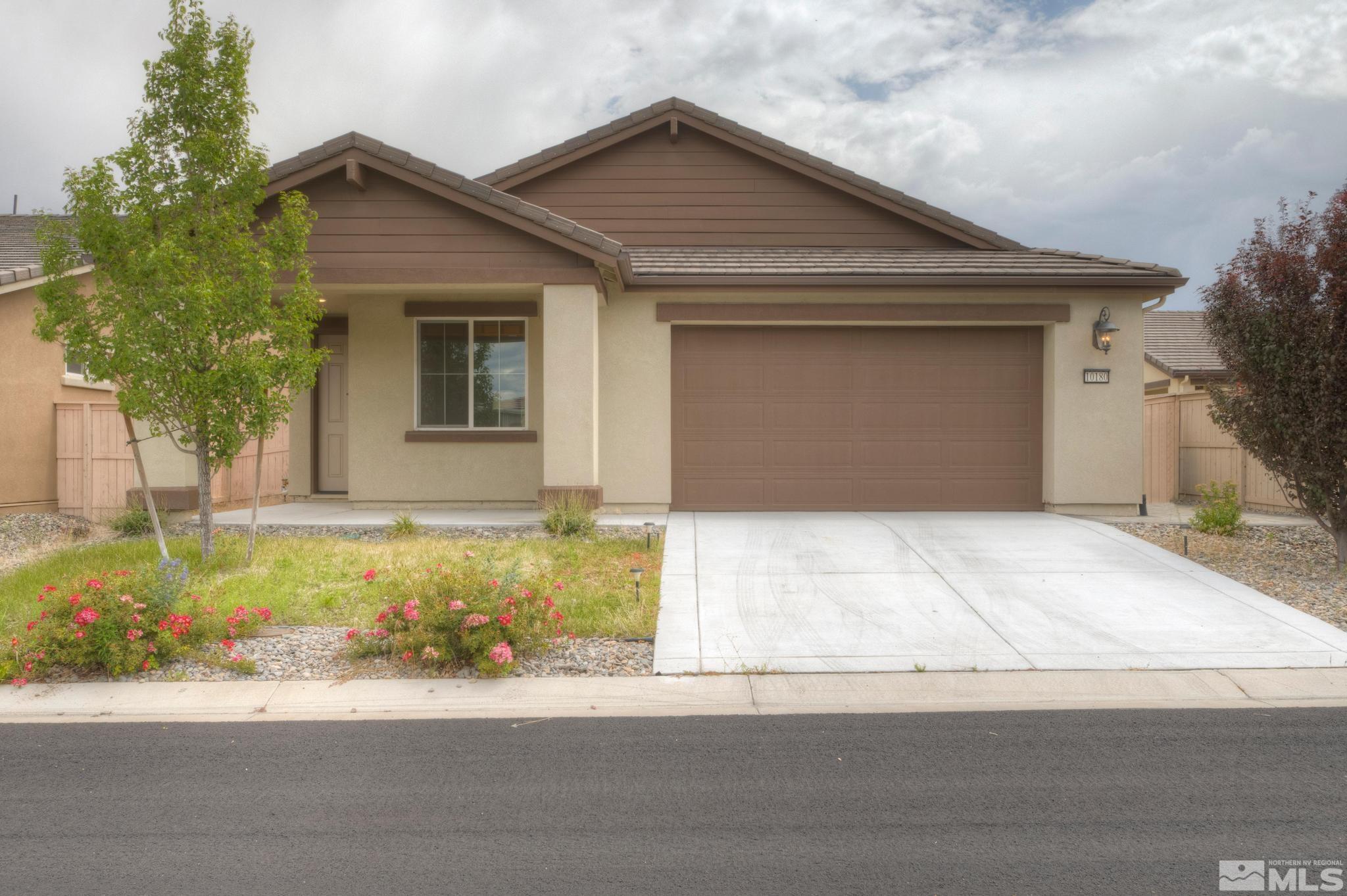 10180 Culiacan Pass Trail Reno, NV 89521 - Photo 1 of 34 a front view of a house with a yard and garage