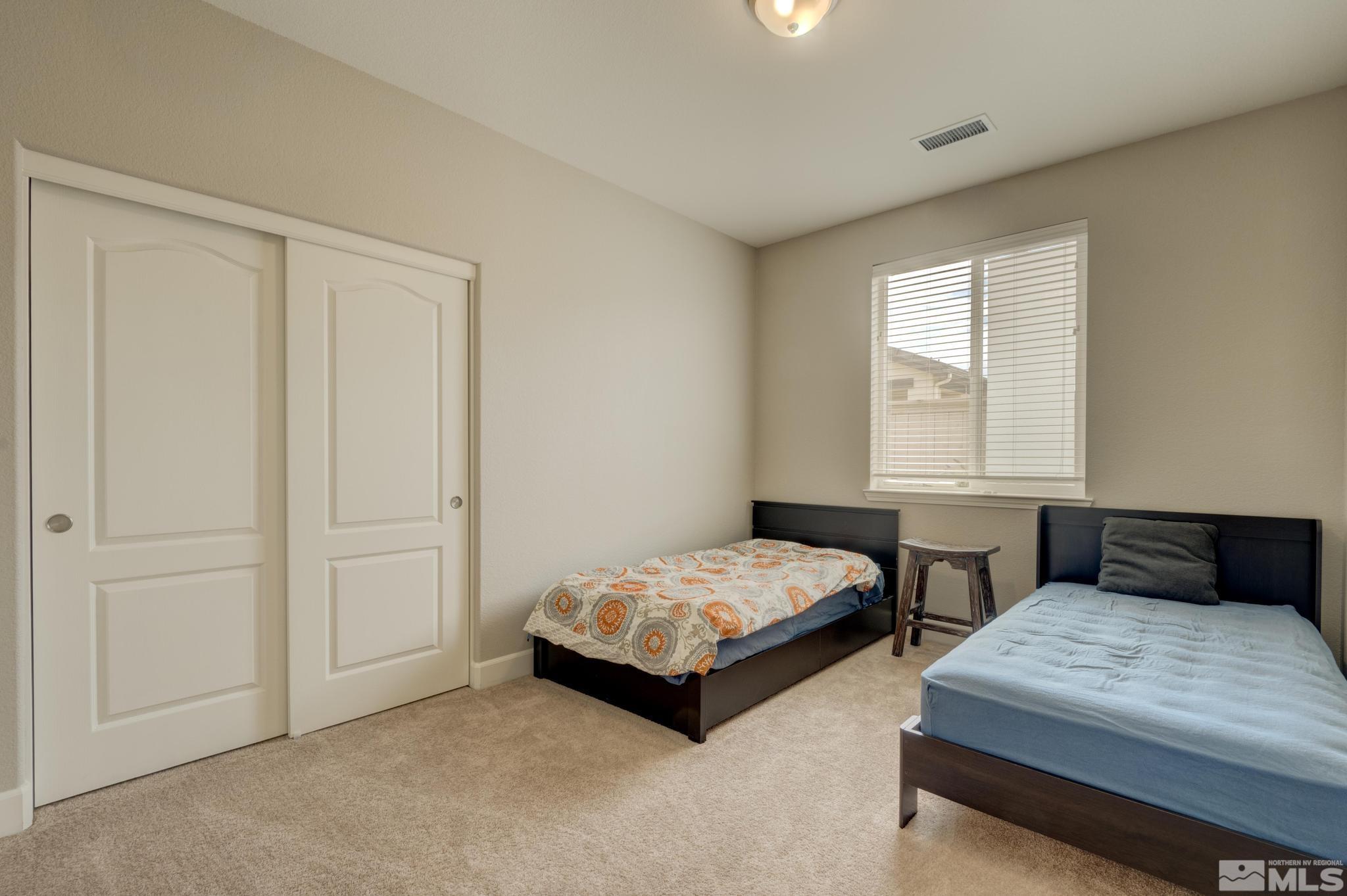 10180 Culiacan Pass Trail Reno, NV 89521 - Photo 21 of 34 a bedroom with two beds and painted walls