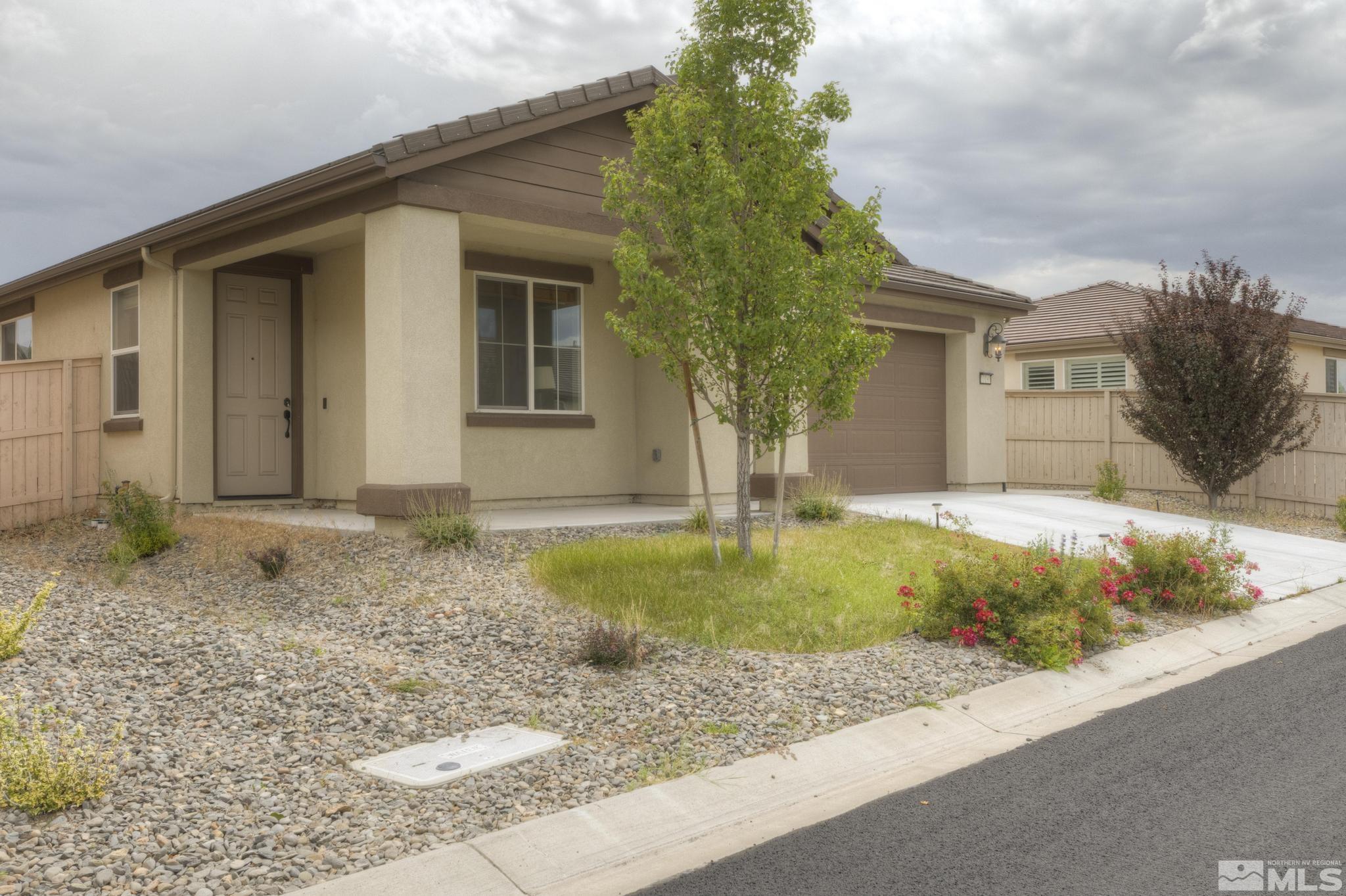 10180 Culiacan Pass Trail Reno, NV 89521 - Photo 3 of 34 a front view of a house with garden