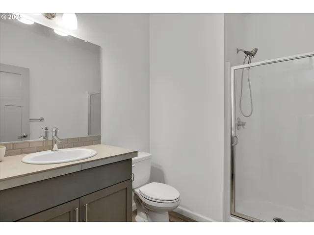 a bathroom with a sink toilet and a mirror