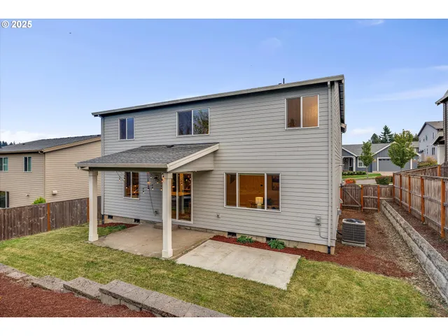 a backyard of a house with yard and furniture