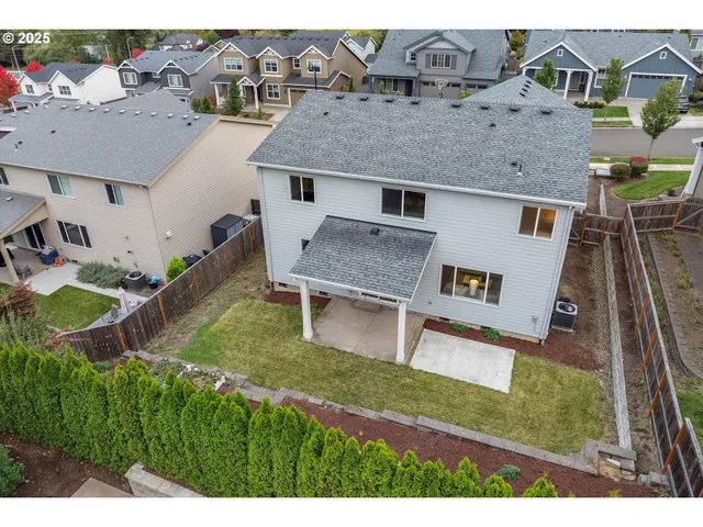 an aerial view of a house with a yard