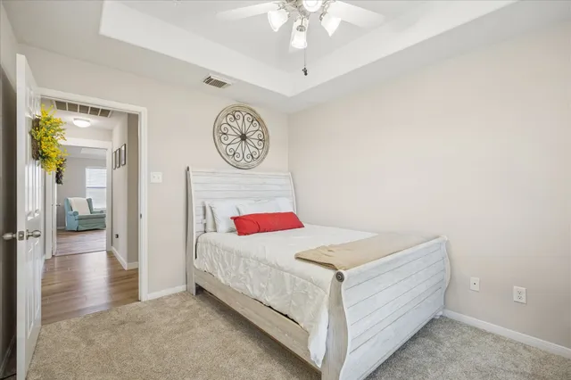 a bedroom with a bed and a chandelier