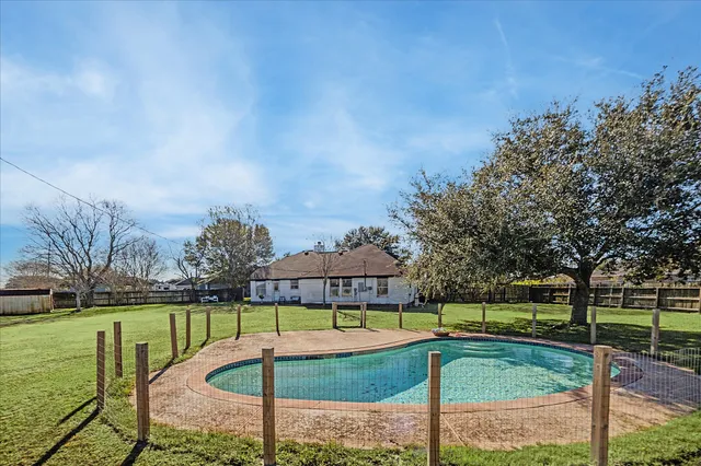 a view of a swimming pool with a garden