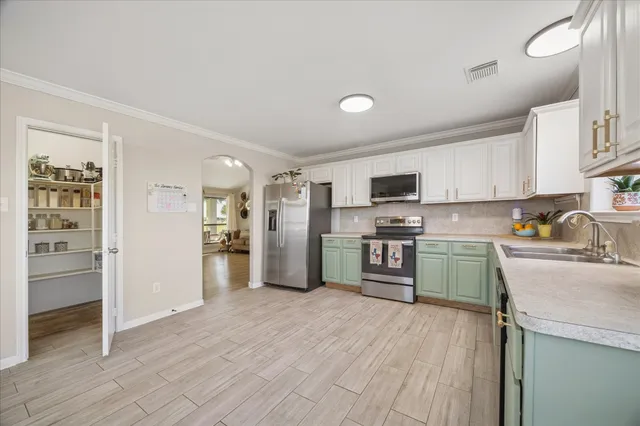 a kitchen with granite countertop stainless steel appliances and refrigerator