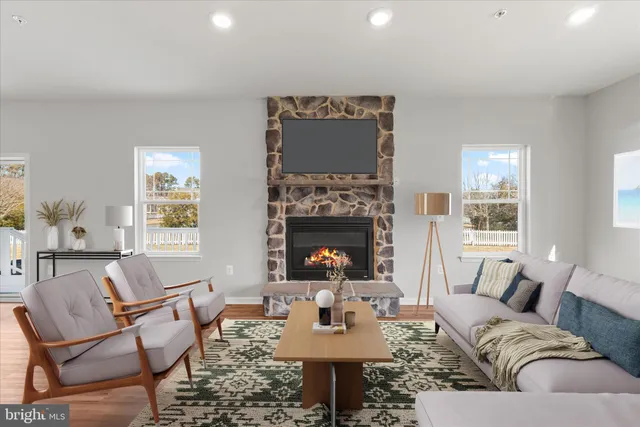a living room with furniture a chandelier and a window