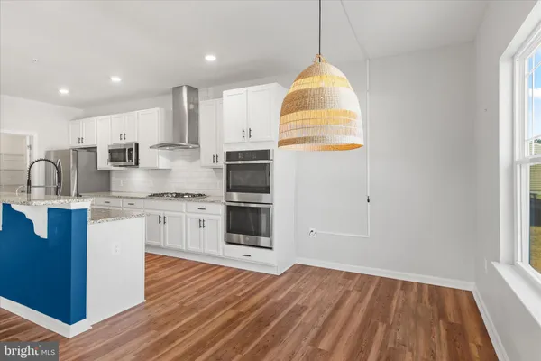 a kitchen with stainless steel appliances granite countertop a stove and a sink