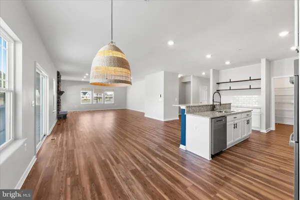 a large kitchen with granite countertop a sink and a stove