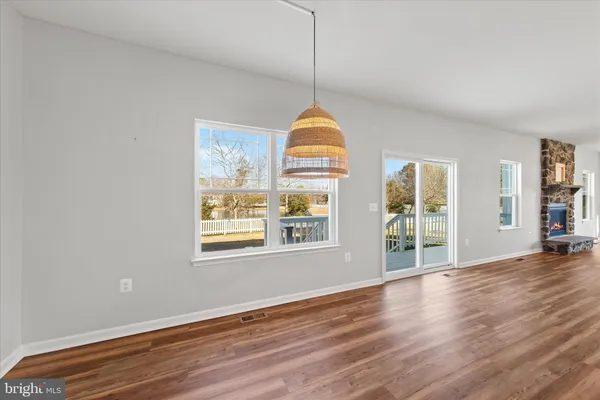 a kitchen with stainless steel appliances granite countertop a refrigerator a stove and white cabinets