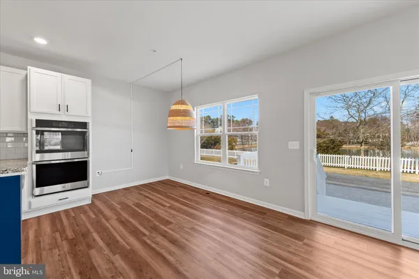 a large kitchen with stainless steel appliances kitchen island a large counter top a stove and a sink