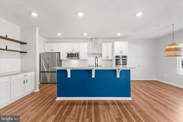 a bedroom with a large bed chandelier and a window