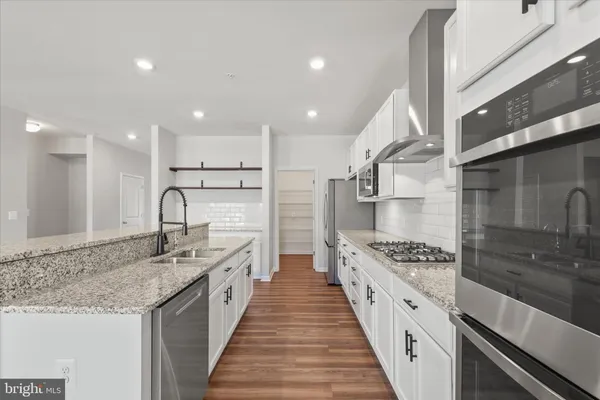a view of entryway and hall with a chandelier fan