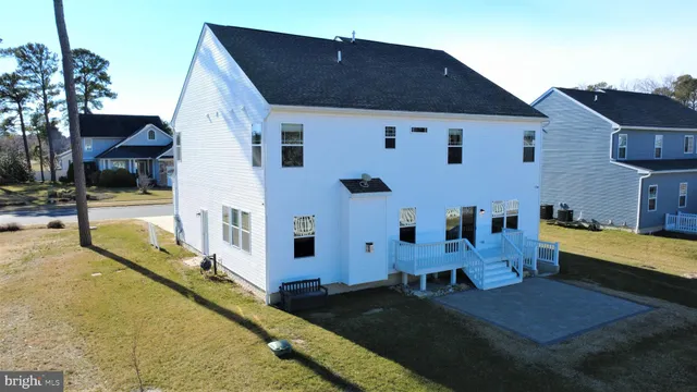 a living room with furniture a fireplace and a large window