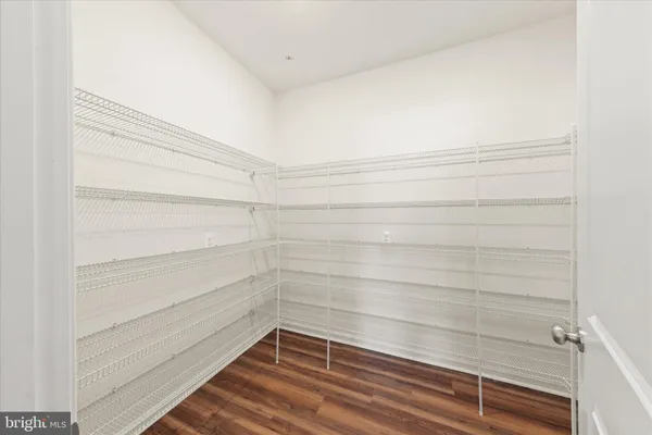 a view of an empty room with a ceiling fan