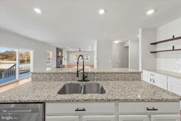 an empty room with a ceiling fan and a window