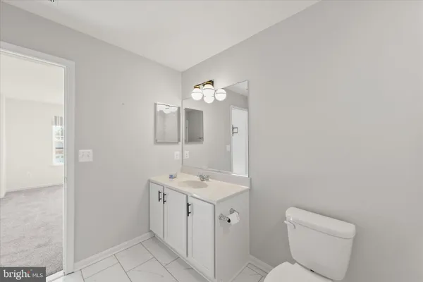 a view of an empty room and a ceiling fan