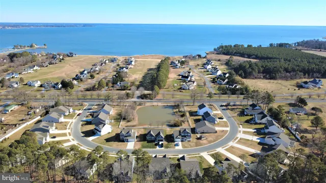 a kitchen with stainless steel appliances granite countertop a refrigerator a sink dishwasher a stove and white countertops with wooden floor