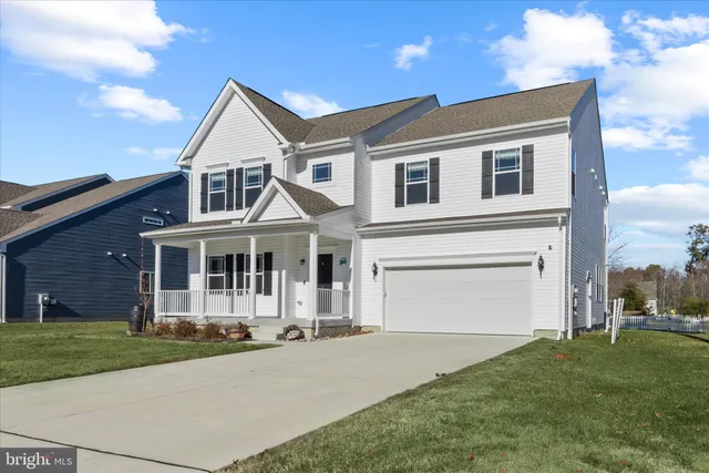 a large kitchen with stainless steel appliances kitchen island a large counter top a stove and a sink