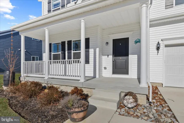 a view of empty room with window and wooden floor