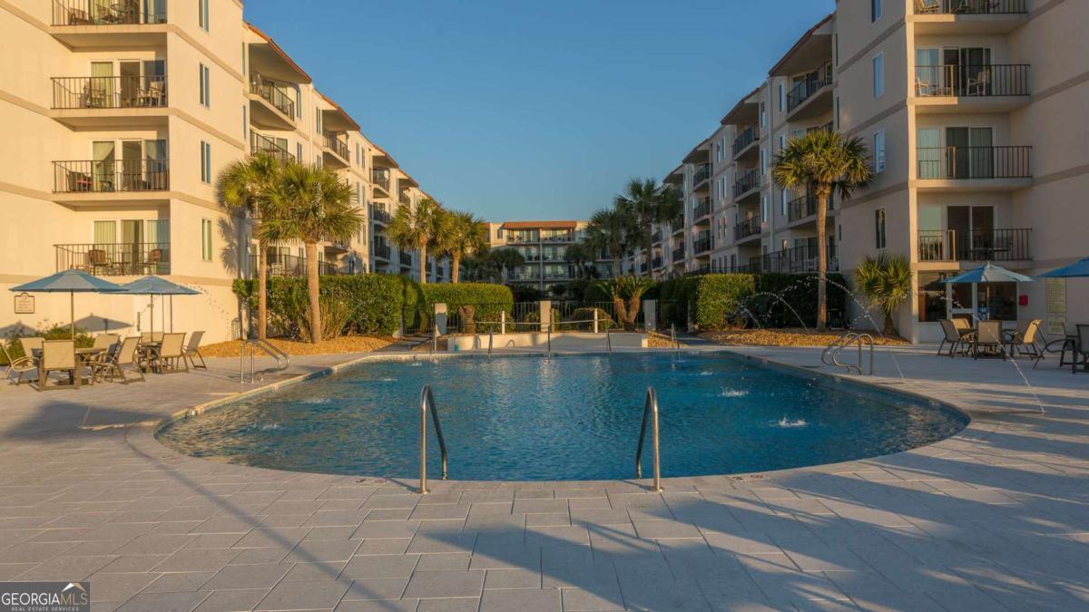 1440 Ocean Boulevard, Unit 224 St. Simons, GA 31522 - Photo 20 of 26 a view of a building with a swimming pool