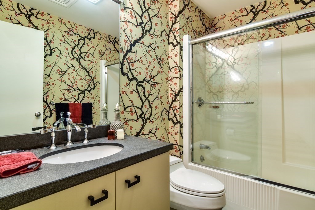 206 Allandale Road, Unit 2D Boston, MA 02467 - Photo 27 of 39 a bathroom with a granite countertop sink toilet and shower