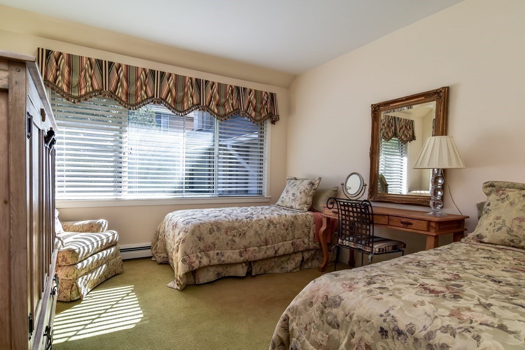 206 Allandale Road, Unit 2D Boston, MA 02467 - Photo 28 of 39 a bedroom with two beds and a window
