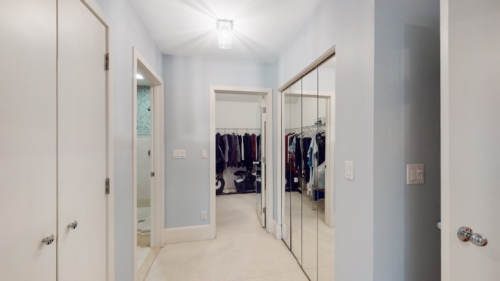 206 Allandale Road, Unit 2D Boston, MA 02467 - Photo 32 of 39 a view of walk in closet with clothes