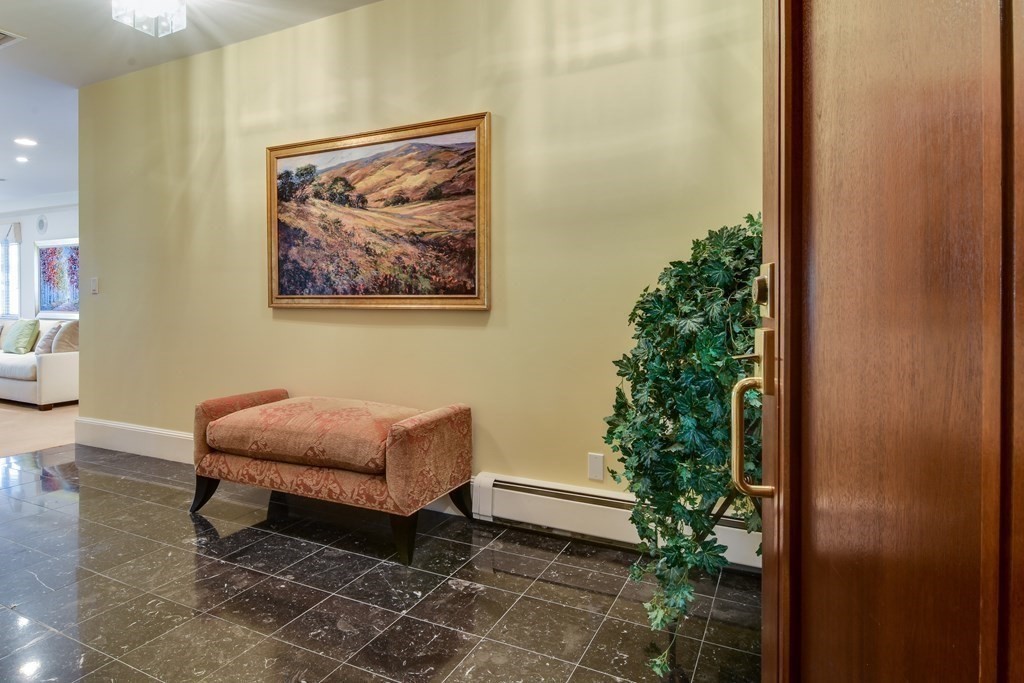 206 Allandale Road, Unit 2D Boston, MA 02467 - Photo 7 of 39 a room with furniture and flowers