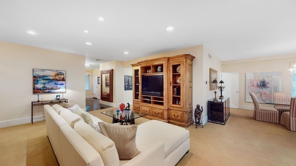 206 Allandale Road, Unit 2D Boston, MA 02467 - Photo 10 of 39 a living room with furniture and a flat screen tv