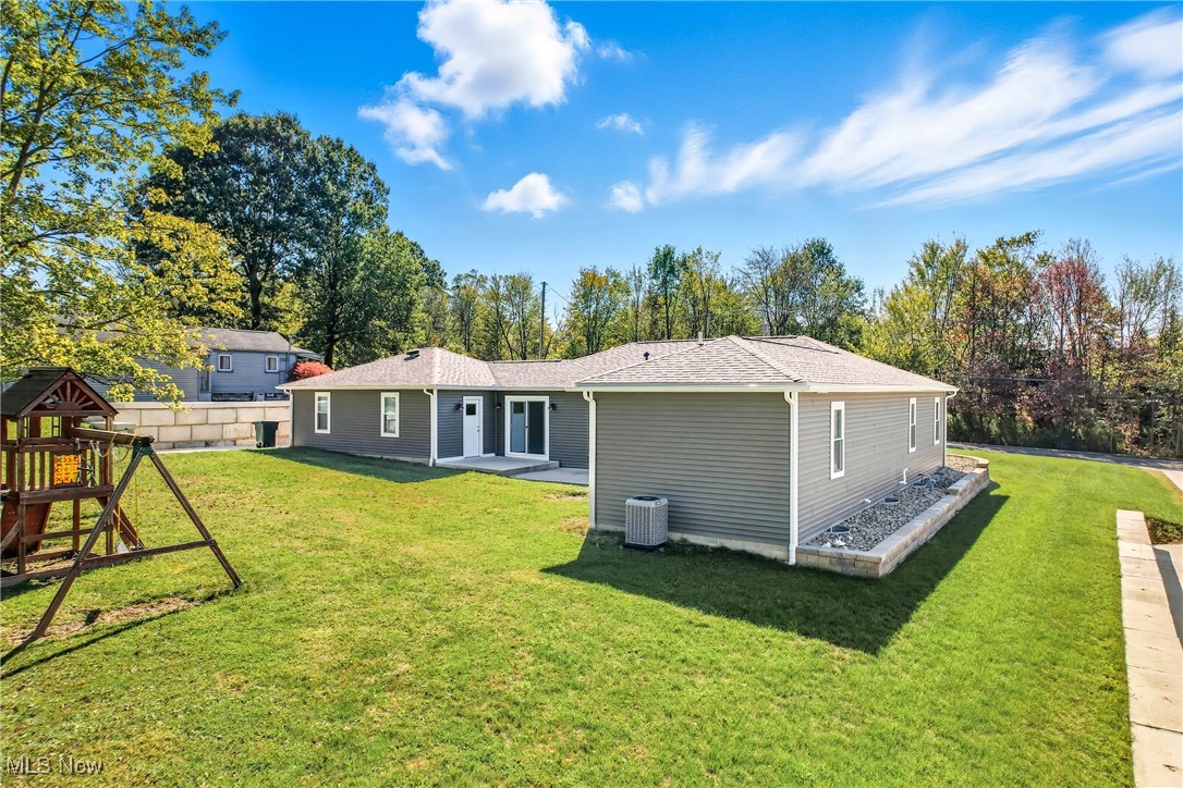 6264 Herbert Road Canfield, OH 44406 - Photo 47 of 47 Rear view of property with a yard, a playground, roof with shingles, and a patio area