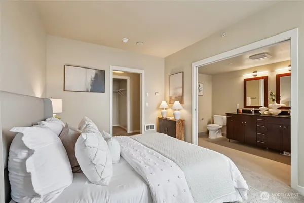 a bedroom with a bed and mirror with window