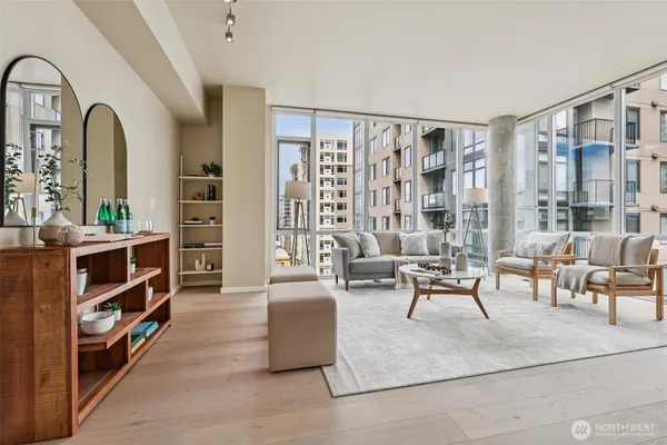 a living room with furniture and a book shelf