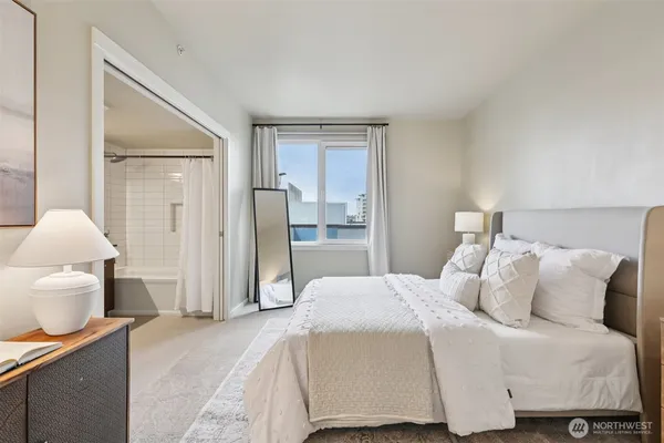 a bedroom with a bed and a lamp