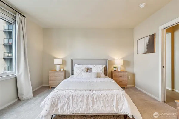 a bedroom with a bed and a window