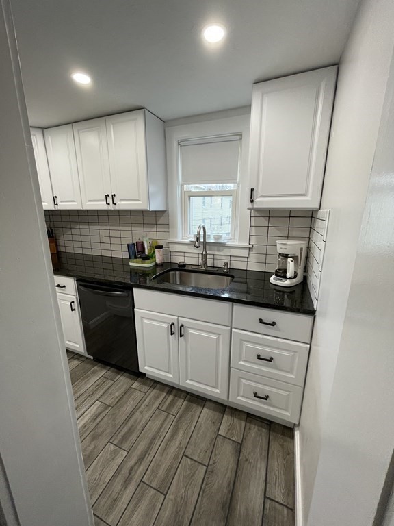 9 Thayer Street Worcester, MA 01603 - Photo 4 of 18 a kitchen with stainless steel appliances granite countertop a sink a stove and cabinets