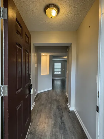 a view of hallway with wooden floor