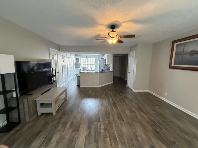 a view of entryway and hall with wooden floor