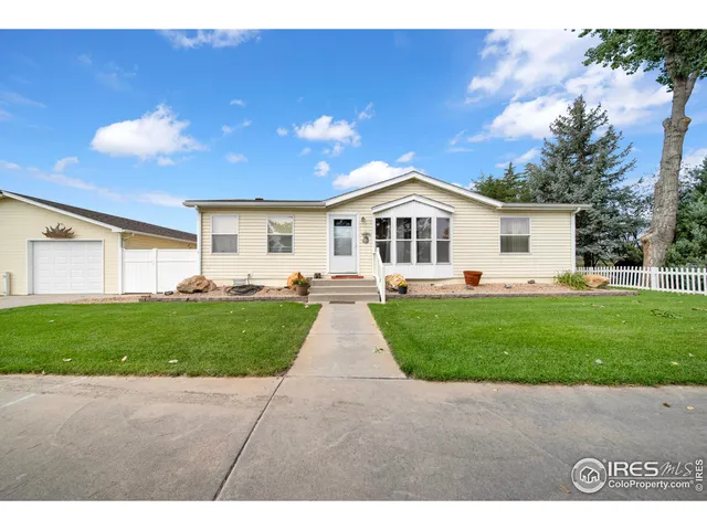 a view of a yard in front of a house with green space
