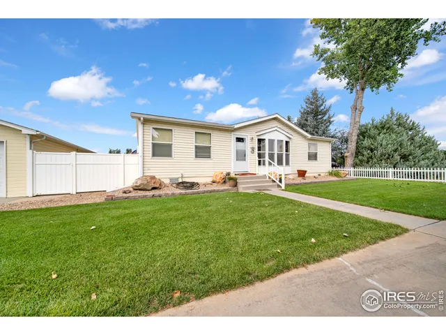 a front view of a house with a garden and yard