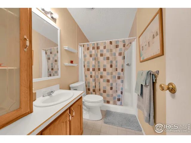 a bathroom with a sink a toilet a shower and a mirror