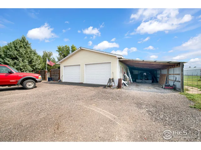 a view of a house with a yard and garage