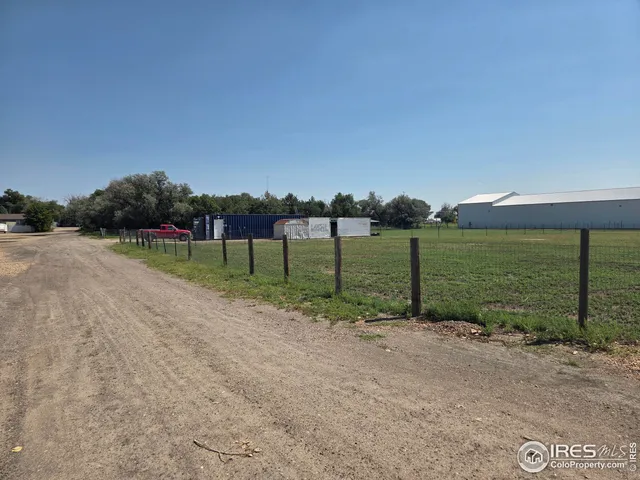 a view of a field with sitting area