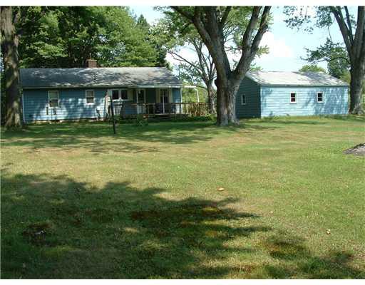 413 Meadow Mist Road Pulaski, PA 16143 - Photo 15 of 17 Exterior Back. 3.66 A house, deck, and garage. House before new paint