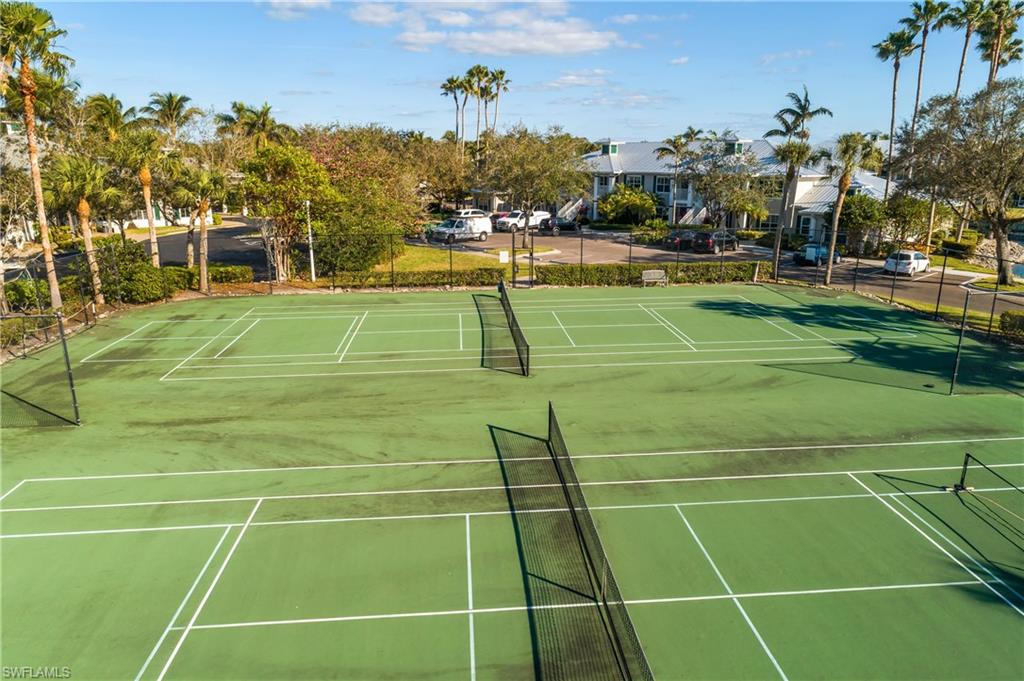 7930 Mahogany Run Lane, Unit 814 Naples, FL 34113 - Photo 28 of 33 a tennis court with view of houses